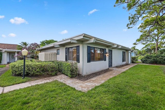 view of property exterior with a lawn