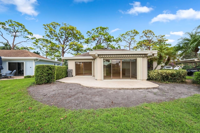 back of property featuring a patio and a yard