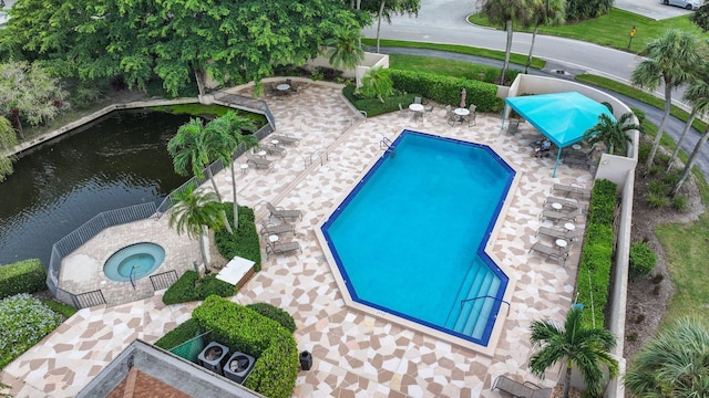 view of pool featuring a community hot tub and a patio area