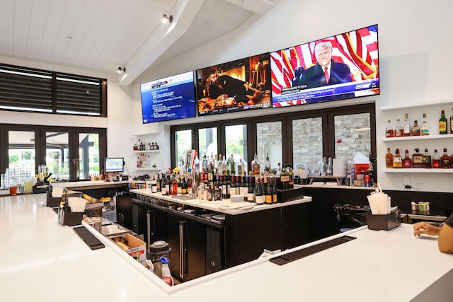 bar featuring wood ceiling, lofted ceiling, track lighting, and french doors