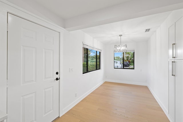 interior space featuring light hardwood / wood-style flooring and a chandelier