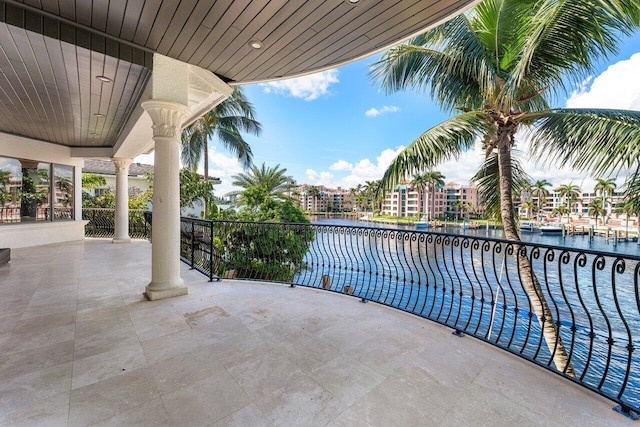 view of patio / terrace featuring a water view and a balcony