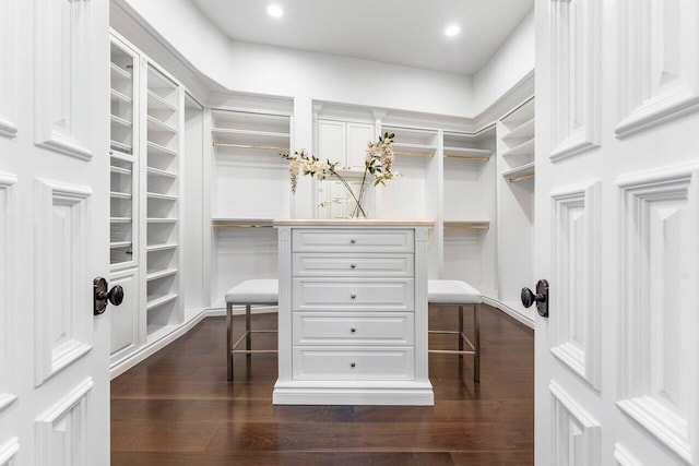 spacious closet featuring dark hardwood / wood-style flooring