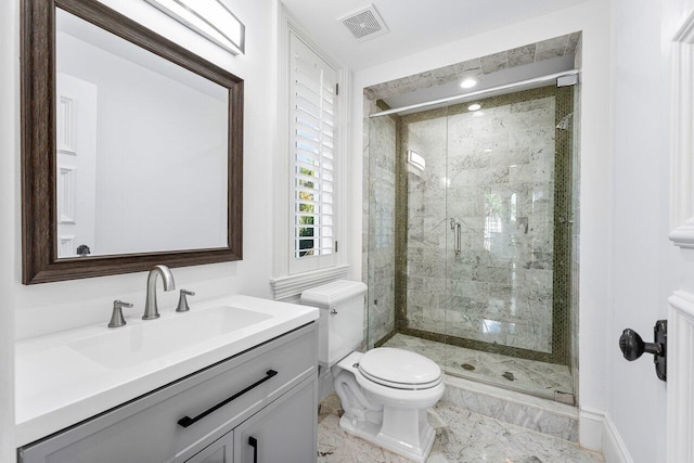 bathroom with vanity, toilet, and a shower with shower door