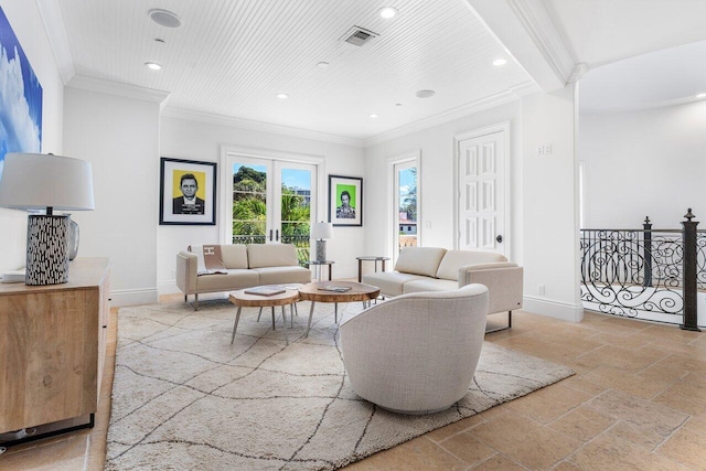 living room with beamed ceiling, ornamental molding, and french doors