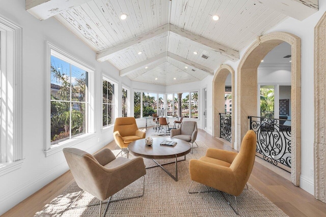 sunroom / solarium featuring vaulted ceiling with beams and wood ceiling