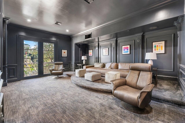 home theater room featuring dark colored carpet, ornamental molding, and french doors