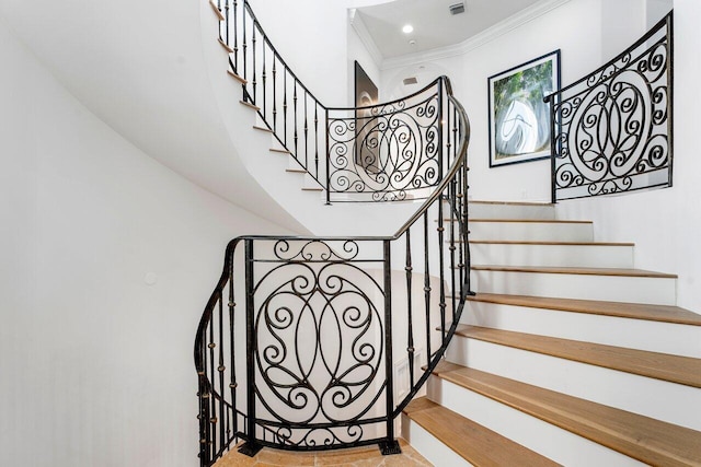 stairs featuring crown molding