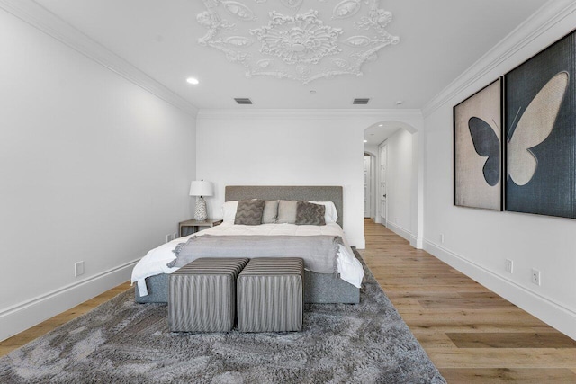 bedroom featuring wood-type flooring and ornamental molding