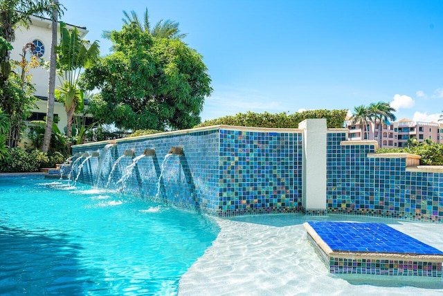 view of swimming pool featuring pool water feature