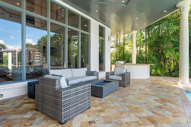 view of patio / terrace with an outdoor living space with a fire pit