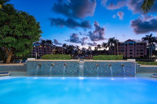 view of pool at dusk