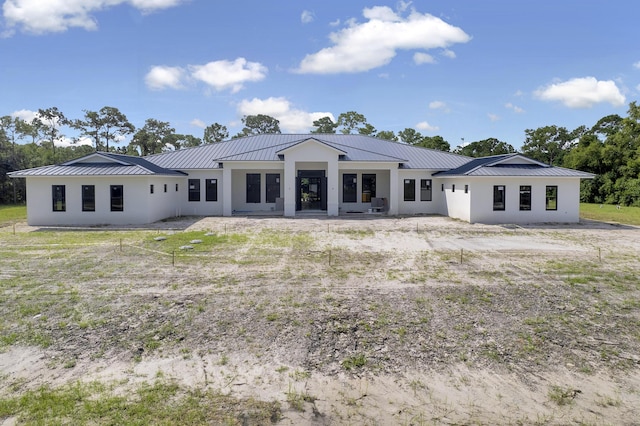 12850 152nd St N, Jupiter, FL 33478 - back of property featuring a standing seam roof, metal roof, and stucco siding