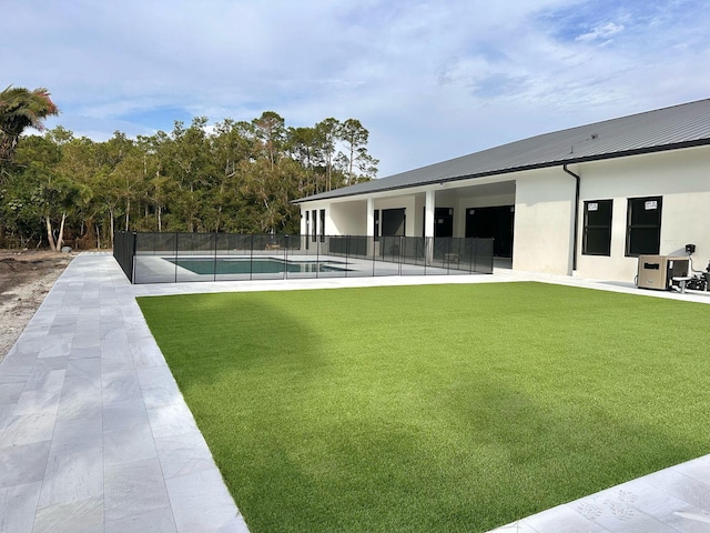 12850 152nd St N, Jupiter, FL 33478 - view of yard featuring a fenced in pool, fence, and a patio area