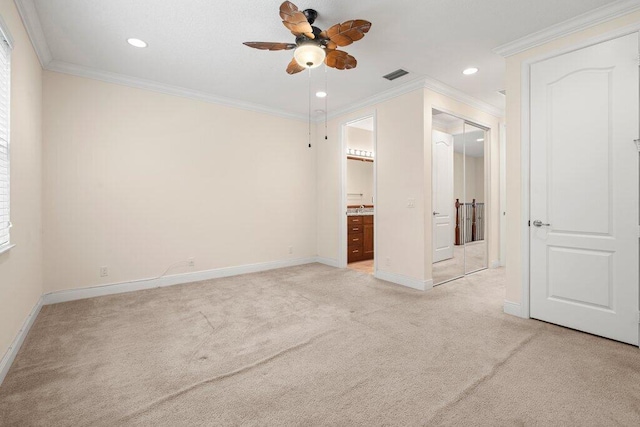 unfurnished bedroom featuring connected bathroom, ornamental molding, light carpet, and ceiling fan