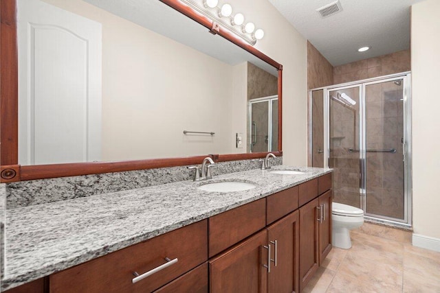 bathroom with walk in shower, vanity, toilet, and tile patterned floors