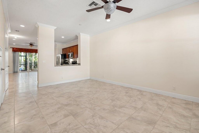 unfurnished living room with ornamental molding, sink, and ceiling fan