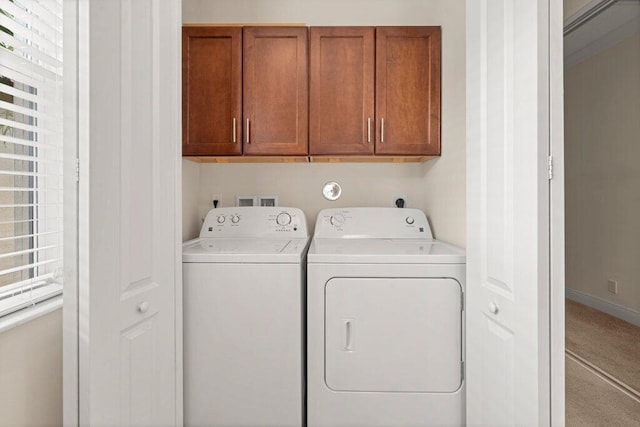 laundry room with cabinets, light carpet, and washer and dryer