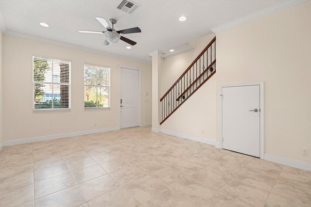 entryway with a textured ceiling, ceiling fan, and crown molding