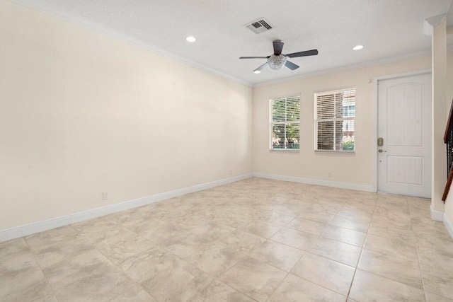 spare room featuring ceiling fan, a textured ceiling, and ornamental molding