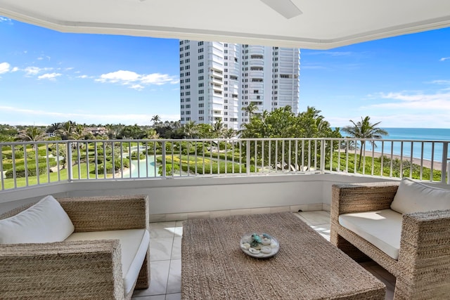 balcony with a water view and an outdoor living space