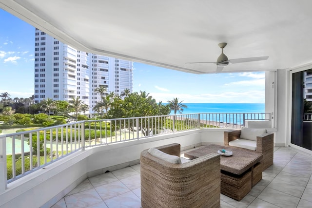 balcony featuring ceiling fan and a water view