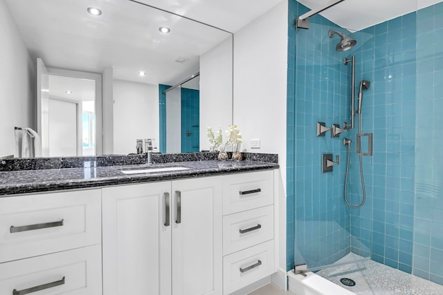 bathroom with vanity and a shower with shower door