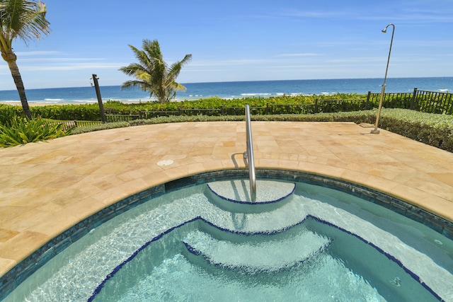 view of swimming pool featuring a water view