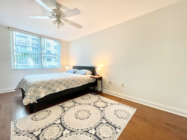 bedroom with dark wood-type flooring and ceiling fan