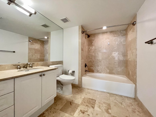 full bathroom with toilet, tiled shower / bath combo, and vanity