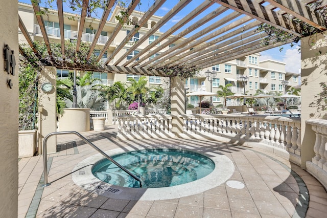 view of patio / terrace featuring a pergola and a community hot tub