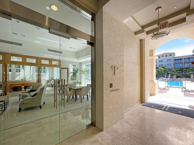 interior space with a community pool and a patio area