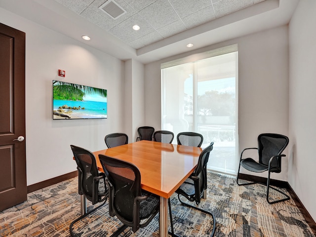 dining area with a paneled ceiling