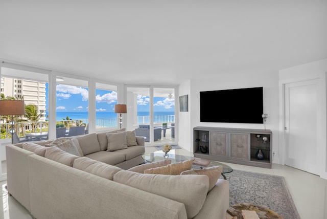 tiled living room featuring a wall of windows