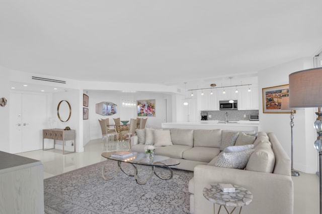 living room featuring sink and light tile patterned floors