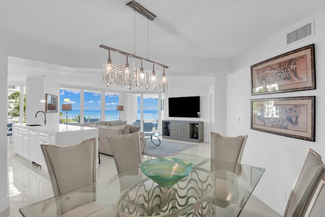 dining room with a chandelier, plenty of natural light, and sink