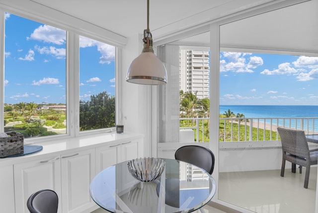 sunroom / solarium featuring a water view