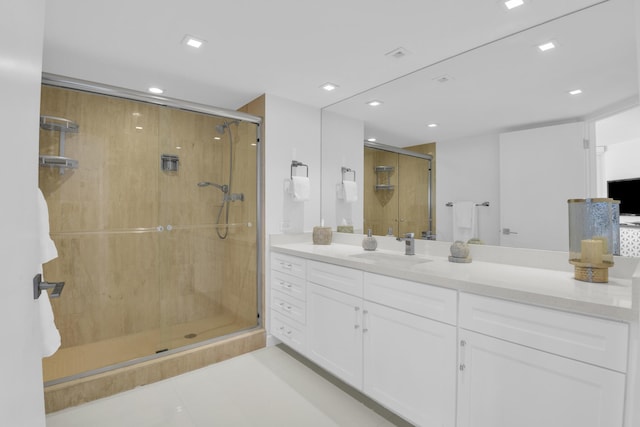 bathroom featuring tile patterned floors, walk in shower, and vanity