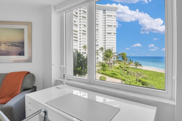 home office with a water view, a beach view, and a wealth of natural light