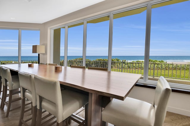 sunroom with a water view and a beach view