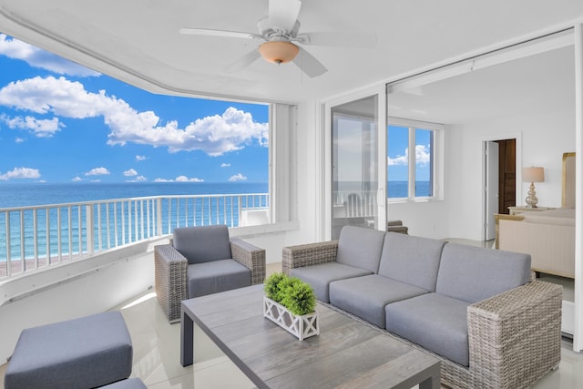 interior space featuring a view of the beach, a water view, and ceiling fan