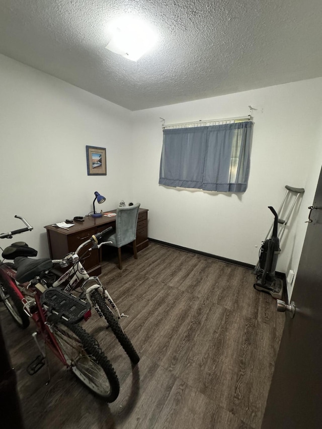 office with dark hardwood / wood-style floors and a textured ceiling