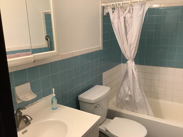 full bathroom with vanity, tile walls, shower / tub combo, and toilet