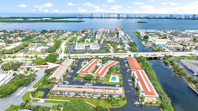 birds eye view of property featuring a view of city and a water view