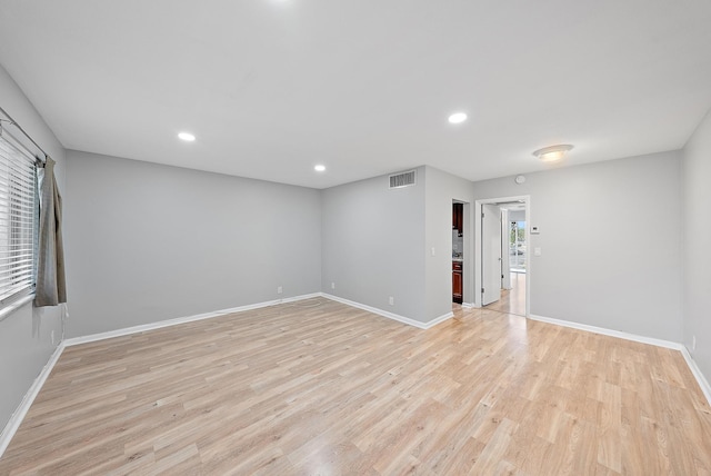 spare room with baseboards, visible vents, light wood finished floors, and recessed lighting