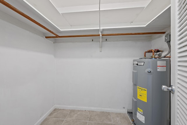 utility room featuring water heater