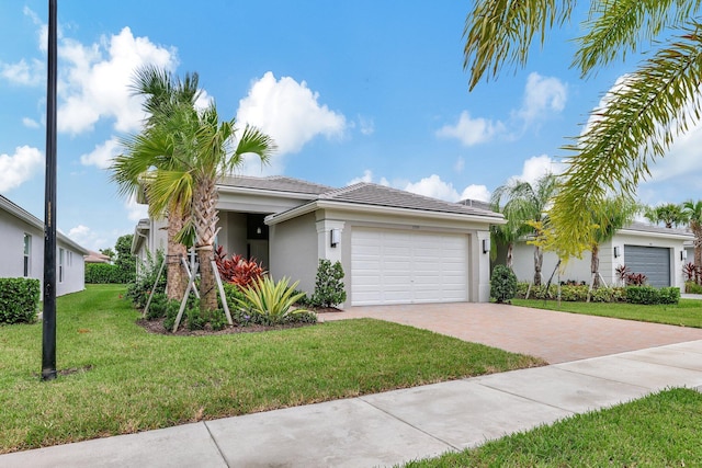 view of front facade with a garage and a front lawn