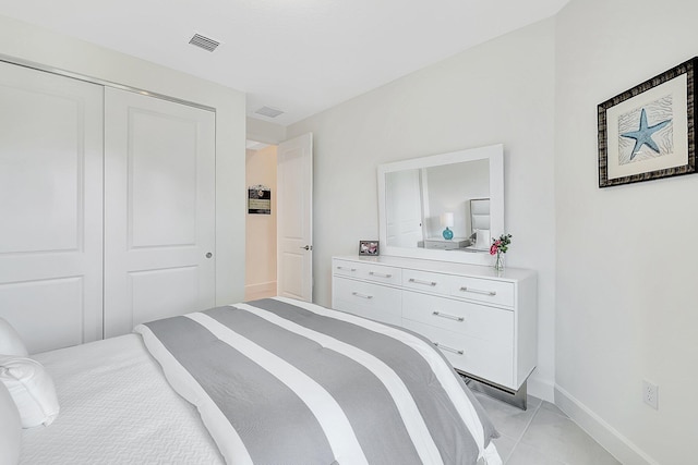 tiled bedroom with a closet