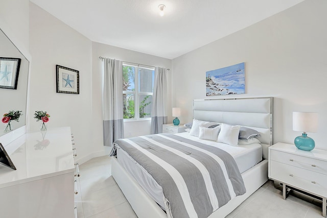 bedroom with light tile patterned floors