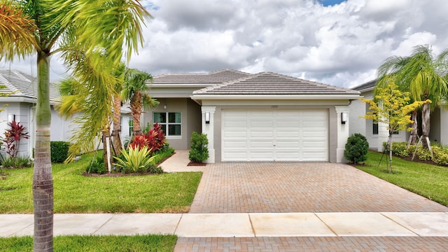 view of front facade with a front yard and a garage